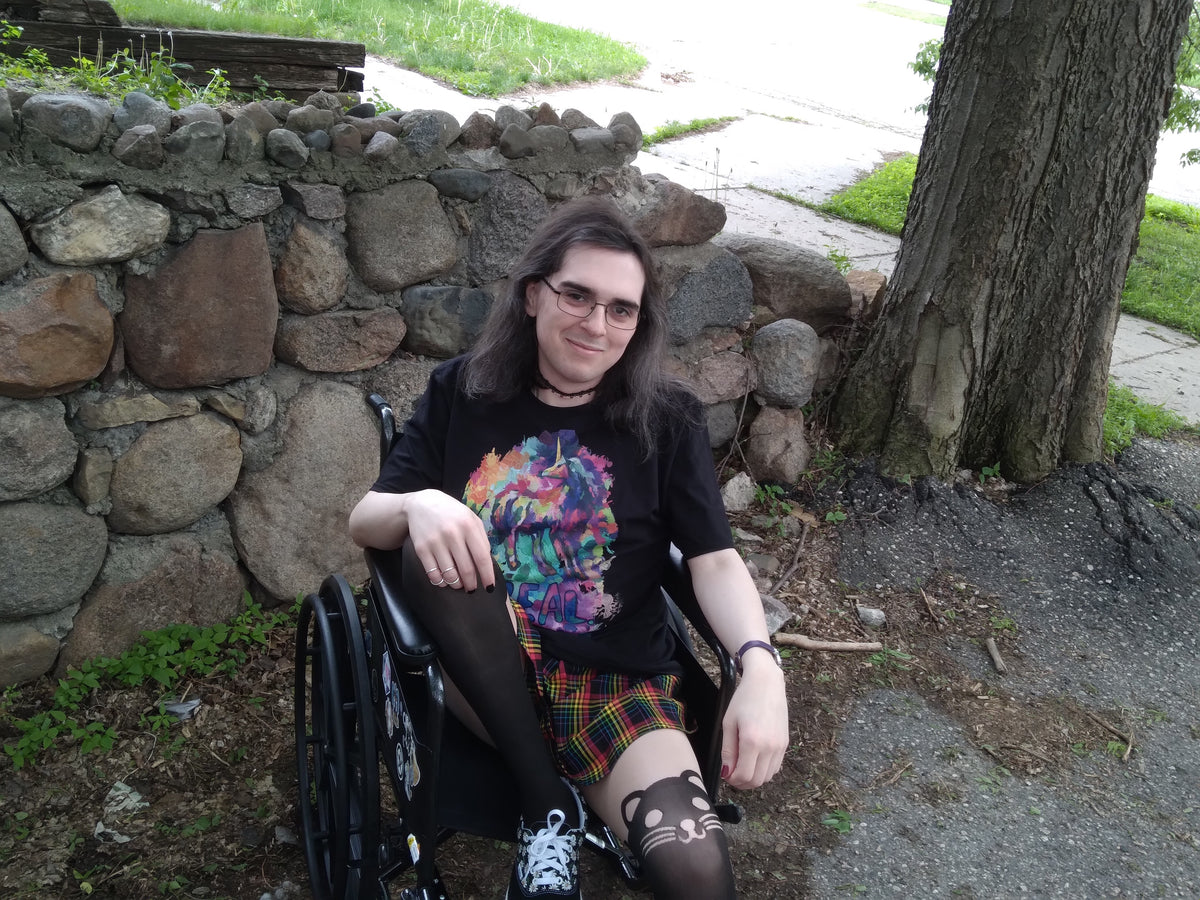 A photo of a handicapped person with eyeglasses wearing a unicorn symbolism-infused t-shirt from Real Unicorn Apparel