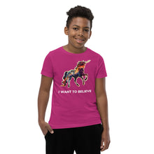 Load image into Gallery viewer, A berry-color t-shirt for youths from Real Unicorn Apparel. The tee has the phrase &quot;I Want To Believe&quot; below a rainbow-colored unicorn.

