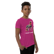 Load image into Gallery viewer, A middle school boy modeling an I Want To Believe Youth Short Sleeve T-Shirt made by Real Unicorn Apparel.
