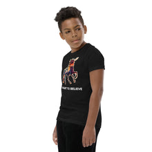 Load image into Gallery viewer, A side profile photo of a pre-teen boy wearing an &quot;I Want To Believe&quot; In Unicorns t-shirt from Real Unicorn Apparel. 

