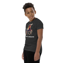 Load image into Gallery viewer, A middle-school boy with a placid expression on his face wearing an &quot;I Want To Believe (In Unicorns)&quot; tee from Real Unicorn Apparel.
