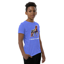 Load image into Gallery viewer, Photograph of a young boy modeling Real Unicorn Apparel&#39;s &quot;I Want To Believe Youth Short Sleeve T-Shirt.&quot;
