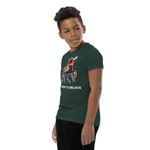 Load image into Gallery viewer, A profile shot of a boy wearing a heather forest I Want To Believe In Unicorns tee with a big colorful unicorn on it from Real Unicorn Apparel.
