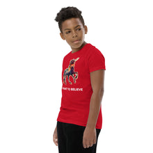 Load image into Gallery viewer, A youngster wearing a red I Want To Believe (In Unicorns) t-shirt from Real Unicorn Apparel.

