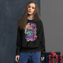 Load image into Gallery viewer, A model wearing a black Real Unicorn Unisex Sweatshirt from Real Unicorn Apparel. The sweatshirt has a graphic of a unicorn with the word &quot;REAL&quot; below its hooves. 
