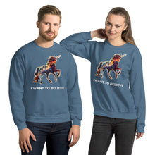 Load image into Gallery viewer, A young and attractive man and woman in indigo blue sweatshirts from Real Unicorn Apparel. The sweatshirts say &quot;I Want To Believe&quot; and feature a rainbow-colored unicorn.
