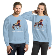 Load image into Gallery viewer, A playful and hip man and woman in light blue sweatshirts from the &quot;I Want To Believe&quot; collection put out by fashion brand Real Unicorn Apparel.
