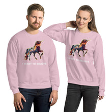 Load image into Gallery viewer, A playful, modern, male-female couple decked out in light pink sweatshirts with a rainbow unicorn from Real Unicorn Apparel. Prominently underneath the unicorn is the text &quot;I Want To Believe.&quot;
