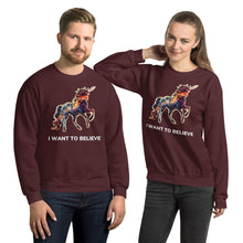 Load image into Gallery viewer, A woman with a playful grin resting her elbow on her man&#39;s shoulder. They&#39;re both wearing sweatshirts from Real Unicorn Apparel with the phrase &quot;I Want To Believe&quot;. 
