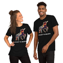 Load image into Gallery viewer, A male-female couple wearing black &quot;I Want To Believe&quot; t-shirts from Real Unicorn Apparel. The shirts feature a rainbow-colored unicorn with text underneath stating &quot;I Want To Believe.&quot;
