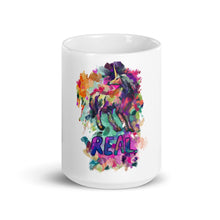 Load image into Gallery viewer, Photograph of the 15 oz. version of the Real Unicorn White Glossy Mug sold by Real Unicorn Apparel. It has a unicorn beautifully drawn by artist Lauren Rubin and the word &quot;REAL&quot; under the unicorn in a colorful display.
