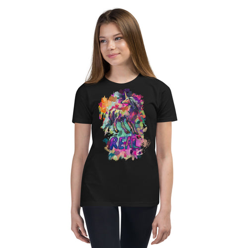 A pre-teen girl wearing a black t-shirt from Real Unicorn Apparel with a gorgeous depiction of a magical mystical unicorn and the word 